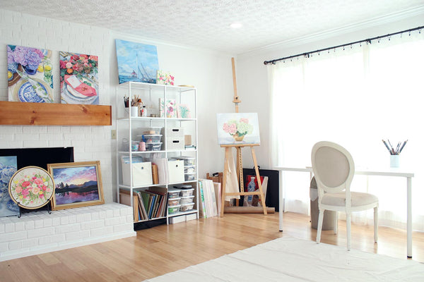White artist painting studio by Elizabeth Alice Studio, art studio shelving storage, easel, table, pretty art studio